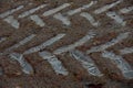 Broad tracks of a tractor on frozen ground