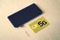 Broadband 5G mobile communication technology concept SIM card tray, dual SIM card slot with two nano SIM cards on wooden