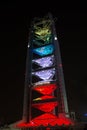 Broadcast tower in brightly colored night illumination