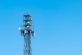 Broadcast tower 5G with satellite dishes against the blue sky. Royalty Free Stock Photo