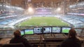 Broadcasters control live event from stadium control room broadcasting to global audience at night Royalty Free Stock Photo