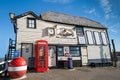 The old life boat station with a red traditional telephone box and buoy outside Royalty Free Stock Photo