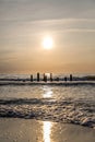 broadways sea at the sunset with eroded wood poles from walkway in the sea