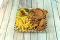 Broaster-style battered chicken pieces with French fries and salad