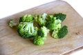 Broccoli cabbage on wood board. Fresh green organic broccoli vegetable on a woofen cutting board on a light rustic wooden backgrou Royalty Free Stock Photo