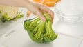 Broccoli, cauliflower, carrot close-up on a kitchen table. Fresh raw organic vegetables close-up on white, woman hands. Cooking, Royalty Free Stock Photo