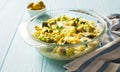 Broccoli, cauliflower, green olives and cheese homemde casserole on blue wooden table