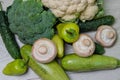 Broccoli and cauliflower with sweet peppers and porcini mushrooms lie on a white table. Two large zucchini Royalty Free Stock Photo