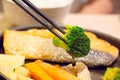 Broccoli in chopsticks Royalty Free Stock Photo