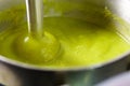 Broccoli cooking close-up blender. Cook green cream soup with vegetables. Royalty Free Stock Photo