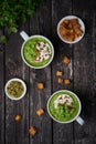 Broccoli cream soup on dark wooden background, vertical, copy space, top view. Vegetable green puree in two large white cup. Diet Royalty Free Stock Photo