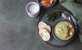 Broccoli cream soup decorated with thyme, cream, roasted cauliflower and fresh bread on green concrete background. Healthy Royalty Free Stock Photo