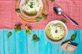 Broccoli cream soup and ingredients on blue wooden table