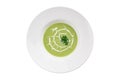 Broccoli and green peas cream soup on white plate isolated on white background Royalty Free Stock Photo