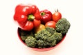 Broccoli, red and yellow tomatoes and bell peppers on plate Royalty Free Stock Photo