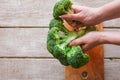 Broccoli separated on parts on wooden background