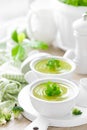 Broccoli soup in bowls on wooden kitchen table closeup. Healthy vegetarian dish Royalty Free Stock Photo