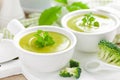 Broccoli soup in bowls on wooden kitchen table closeup. Healthy vegetarian dish Royalty Free Stock Photo