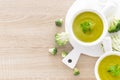 Broccoli soup in bowls on wooden kitchen table closeup. Healthy vegetarian dish. Diet food Royalty Free Stock Photo