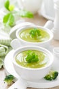 Broccoli soup in bowls on wooden kitchen table closeup. Healthy vegetarian dish. Diet food Royalty Free Stock Photo