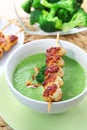 Broccoli soup with skewered chicken Royalty Free Stock Photo