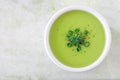 Broccoli soup in white bowl, overhead view on white granite Royalty Free Stock Photo