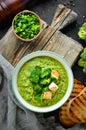 Broccoli, spinach cream soup in a bowl with toasted bread. Green soup. Dietary food.