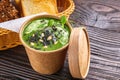 Broccoli spinach cream soup on rustic wooden background