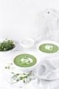 Broccoli and spinach cream soup, served with bread and micro greens on a white wooden table. Vegan food Royalty Free Stock Photo