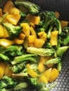 Broccoli and sweet pepper in a hot pan, ready to cook