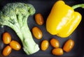 Broccoli, yellow bell peppers and orange cherry tomatoes