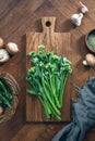 Broccolini fresh bunch on a rustic cutting board ready for cooking