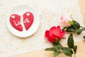 Brocken heart cookie of love and plastic rose Royalty Free Stock Photo