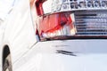 Brocken red taillight without glass and big black scratch on rear bumper due to car accident or careless driving, Royalty Free Stock Photo