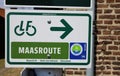 Closeup of isolated direction sign with bike symbol of dutch cycling track maasroute