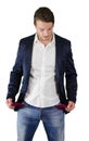 Broke young man looking at empty pockets Royalty Free Stock Photo