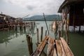 Broken abandoned pier of wooden planks in the Thai fishing village. Travel. Royalty Free Stock Photo