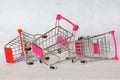 Broken and abandoned supermarket trolleys with a falling wheel on a white background. The crisis in the trade. Decline in Royalty Free Stock Photo