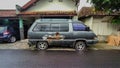 Broken and abandoned Toyota TownAce with skylite roof parked on the side of the roads