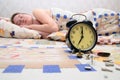 Broken alarm clock near sleeping girl Royalty Free Stock Photo