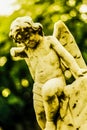 Broken angel cherub statue on a gravestone