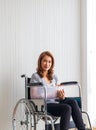 Broken arm woman with arm sling sponsored in her hands sitting on a wheelchair Ideas for accident Injuries and health care
