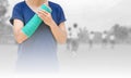 Broken arm with green cast on blurred background kid soccer play