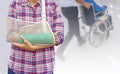 broken arm with green cast and arm sling isolated on blurred background young man pushing a wheelchair and seniors woman sitting Royalty Free Stock Photo