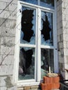 Broken as a result of artillery shelling a window with broken glass Royalty Free Stock Photo