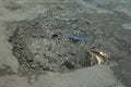 Broken asphalt with a pothole filled with gravel Royalty Free Stock Photo