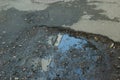 Broken asphalt with a pothole filled with gravel Royalty Free Stock Photo