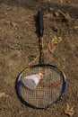 A broken badminton racket with shuttle laying on ground Royalty Free Stock Photo