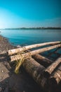 A broken bamboo canoe stranded on the edge of the lake