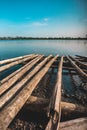 A broken bamboo canoe stranded on the edge of the lake